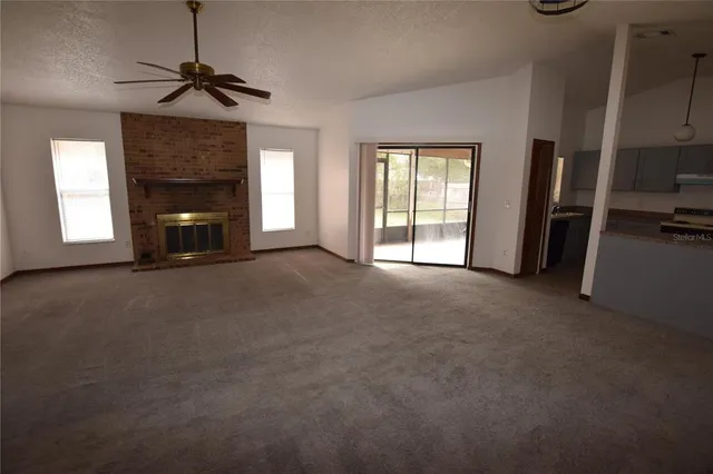 a view of empty room with a fireplace