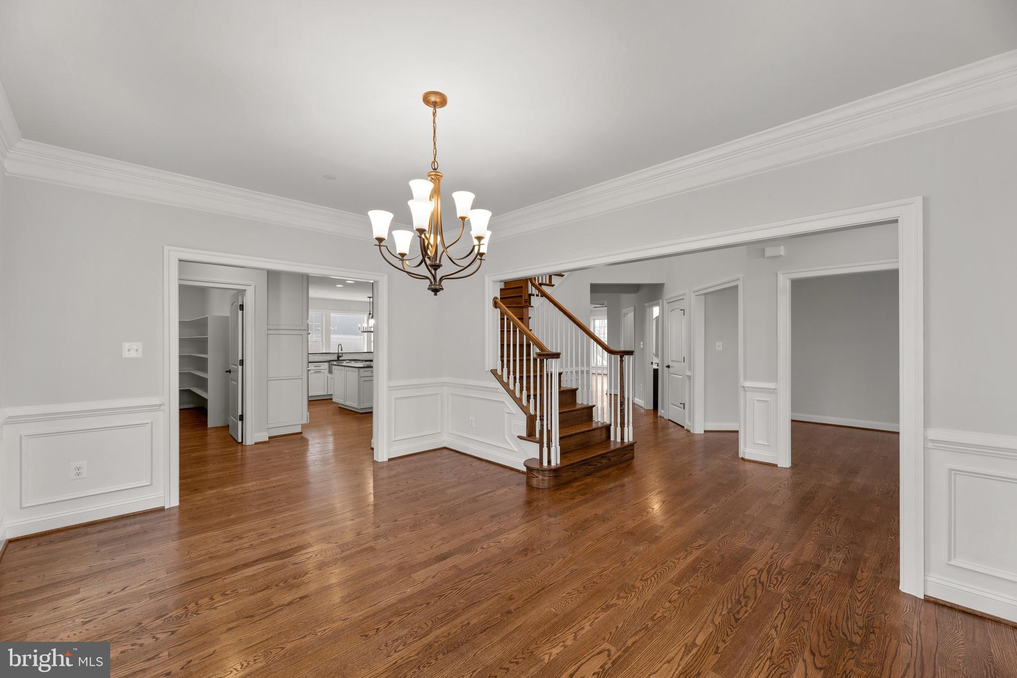 14628 Old Hanover Road, Unit TULARE Reisterstown, MD 21136 - Photo 11 of 60 a view of a livingroom with wooden floor staircase and a chandelier