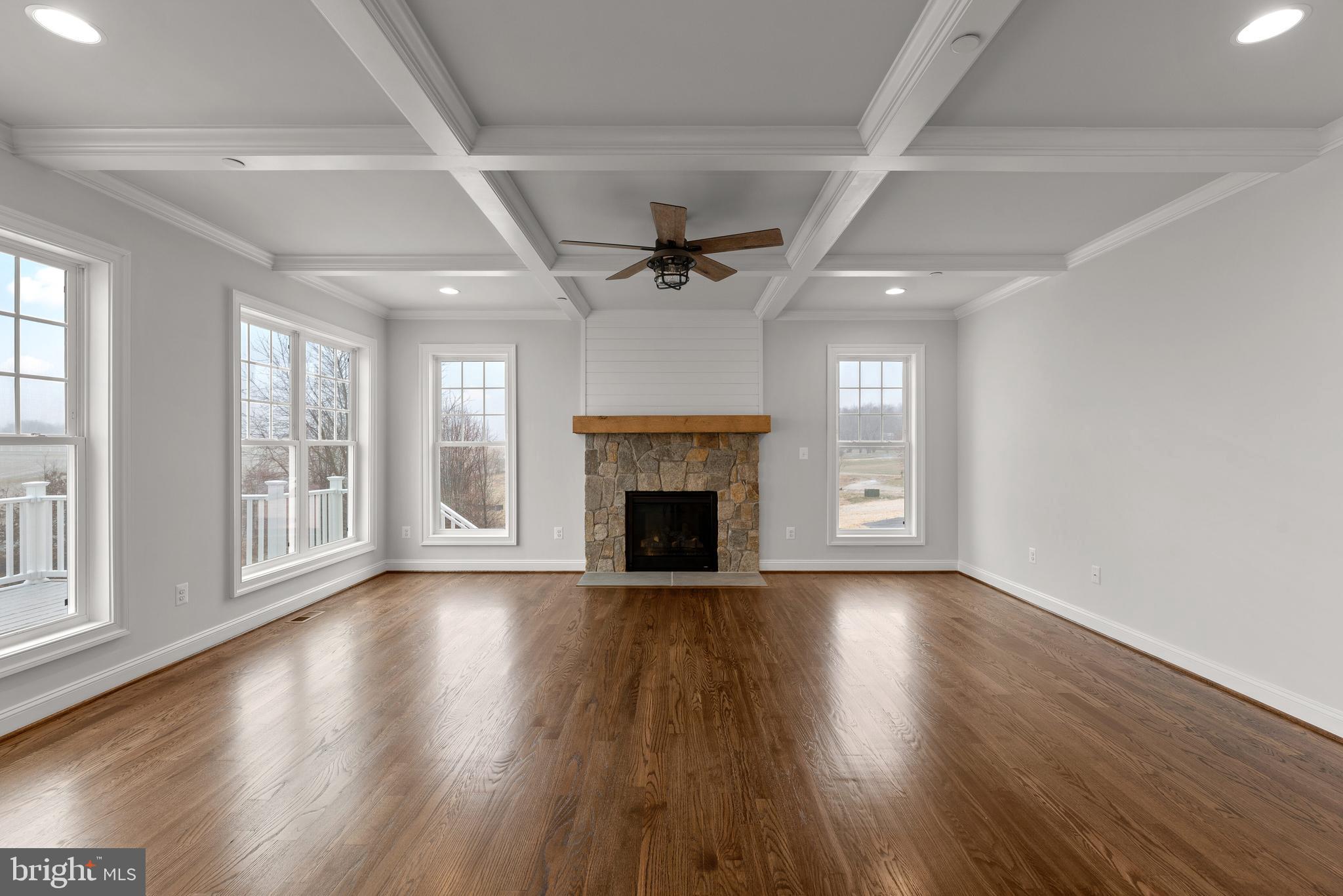 14628 Old Hanover Road, Unit TULARE Reisterstown, MD 21136 - Photo 14 of 60 a view of an empty room with wooden floor fireplace and a window
