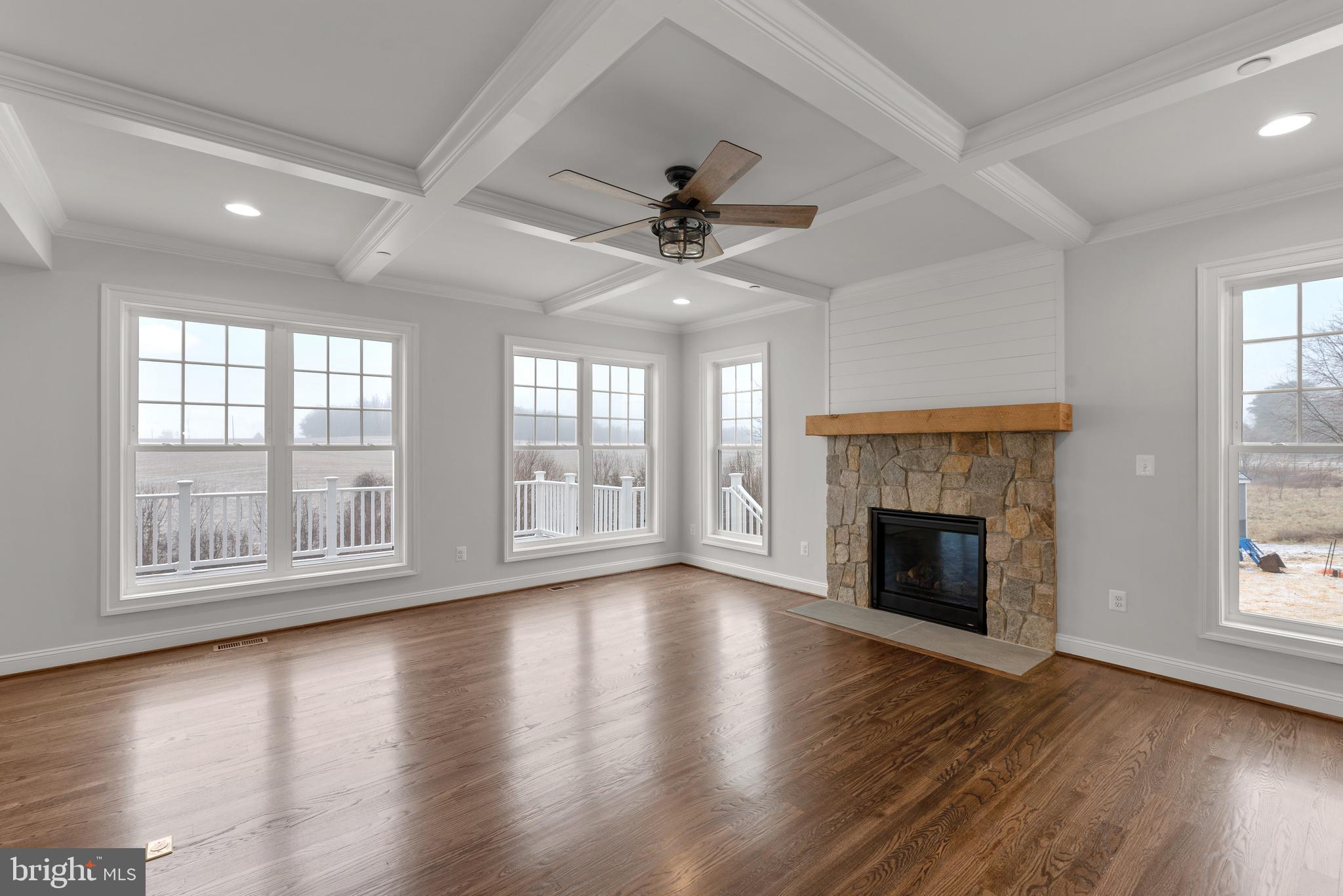 14628 Old Hanover Road, Unit TULARE Reisterstown, MD 21136 - Photo 16 of 60 an empty room with wooden floor fireplace and windows
