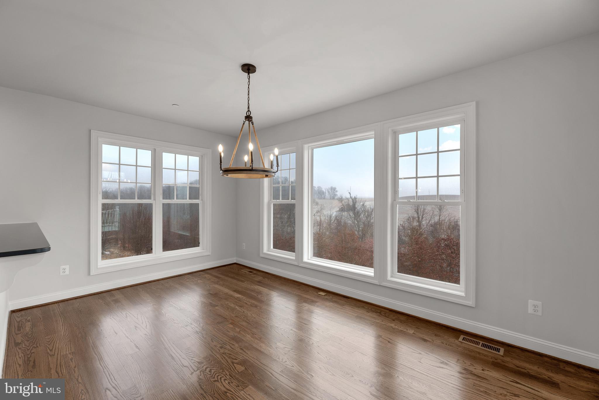 14628 Old Hanover Road, Unit TULARE Reisterstown, MD 21136 - Photo 19 of 60 a view of an empty room with wooden floor and a window