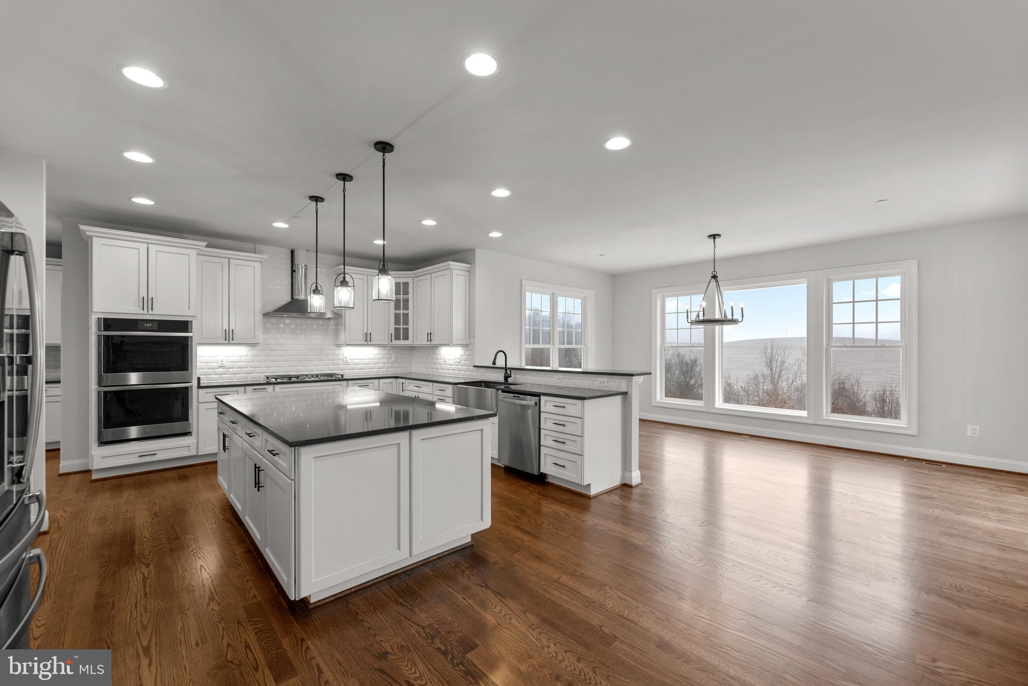 14628 Old Hanover Road, Unit TULARE Reisterstown, MD 21136 - Photo 23 of 60 a large kitchen with stainless steel appliances granite countertop a stove and a wooden floors