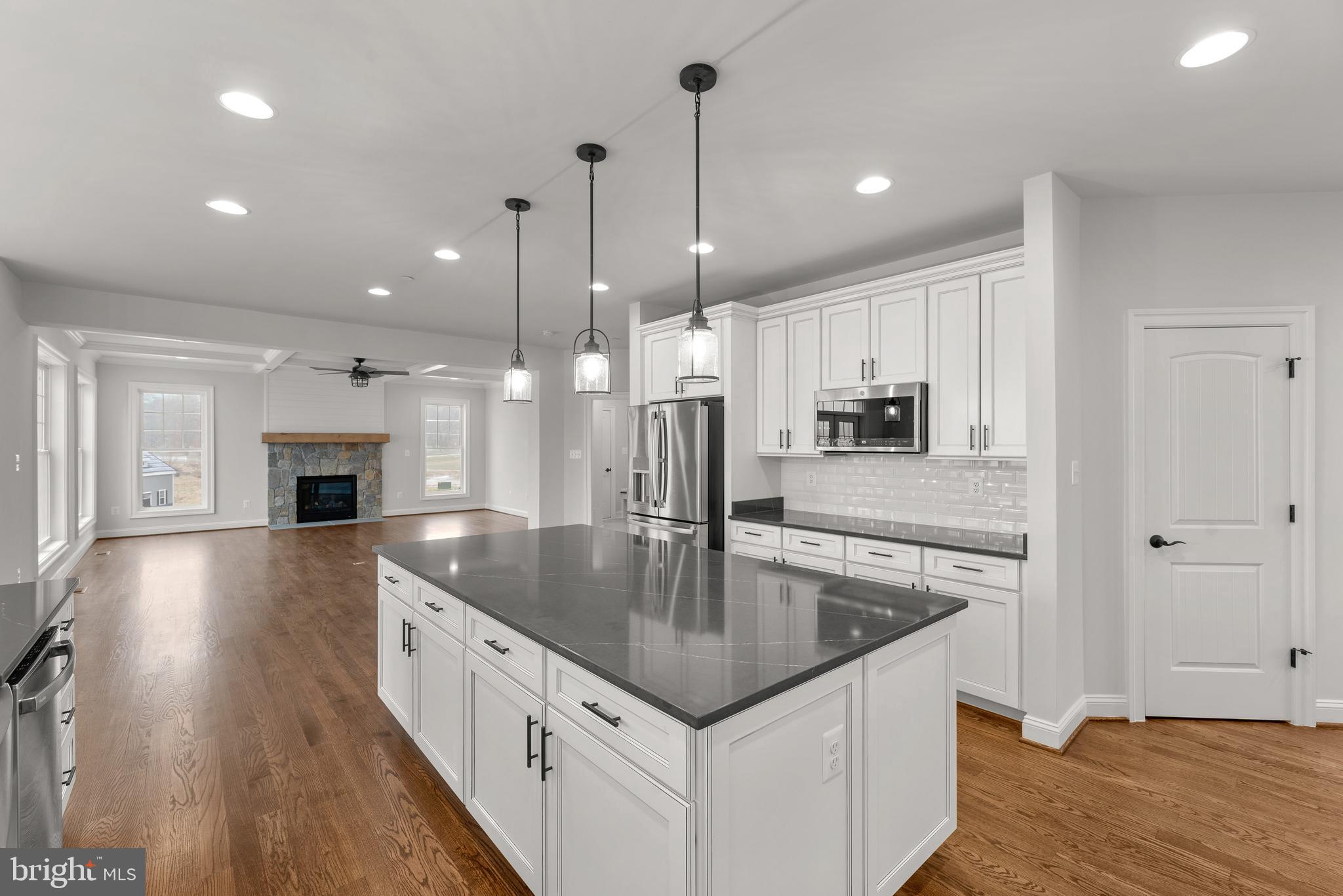 14628 Old Hanover Road, Unit TULARE Reisterstown, MD 21136 - Photo 25 of 60 a kitchen with stainless steel appliances granite countertop a sink a oven and a refrigerator