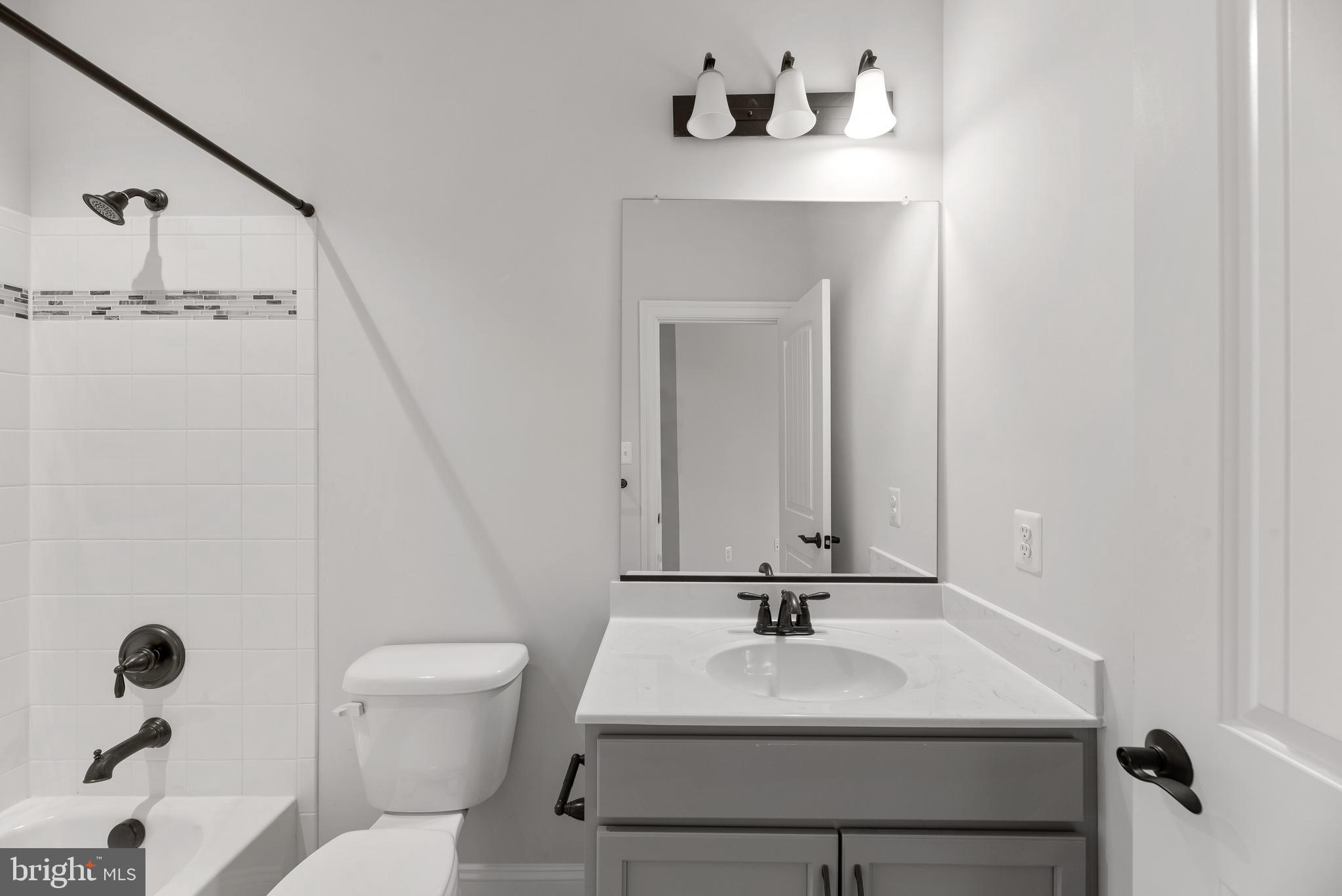 14628 Old Hanover Road, Unit TULARE Reisterstown, MD 21136 - Photo 40 of 60 a bathroom with a sink toilet and mirror