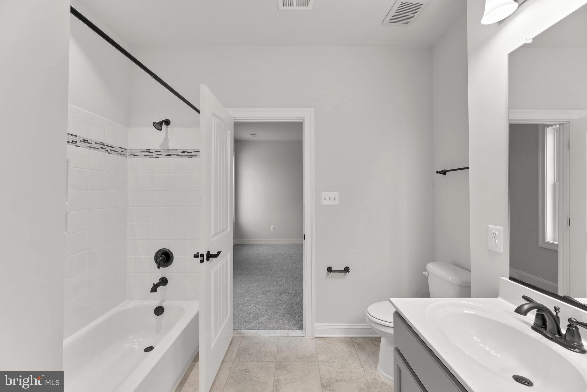 14628 Old Hanover Road, Unit TULARE Reisterstown, MD 21136 - Photo 44 of 60 a bathroom with a tub sink and mirror