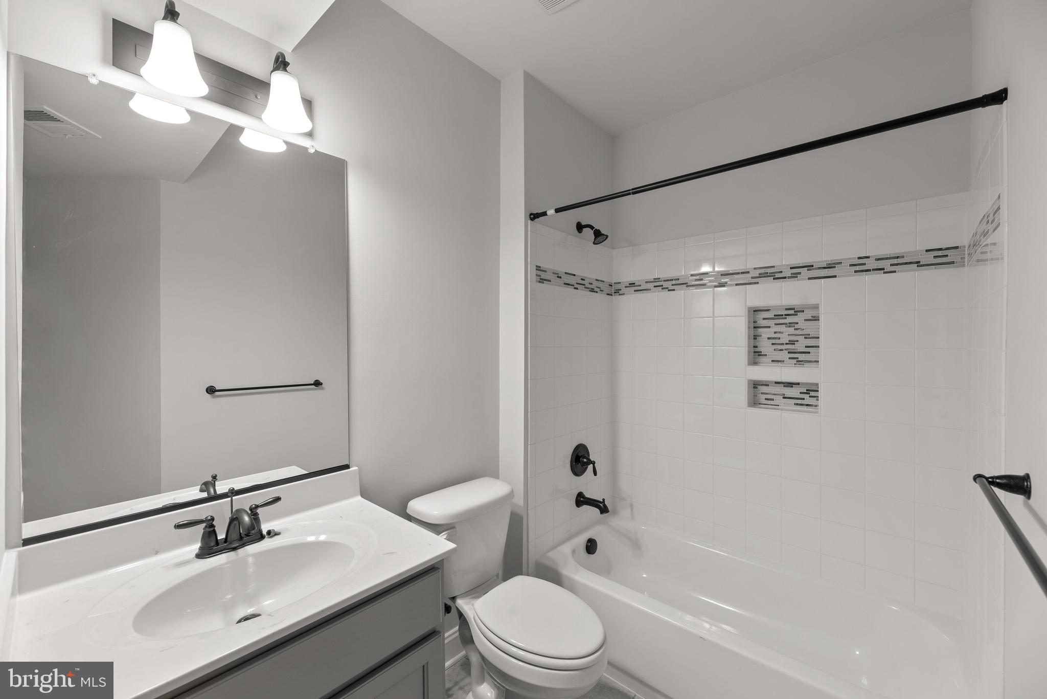 14628 Old Hanover Road, Unit TULARE Reisterstown, MD 21136 - Photo 51 of 60 a bathroom with a sink vanity mirror and toilet