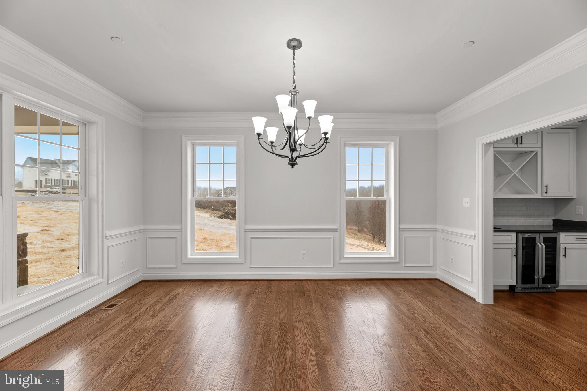 14628 Old Hanover Road, Unit TULARE Reisterstown, MD 21136 - Photo 10 of 60 an empty room with wooden floor and windows