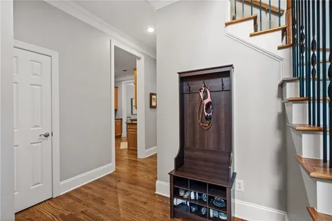 a view of a hallway with wooden floor and entryway