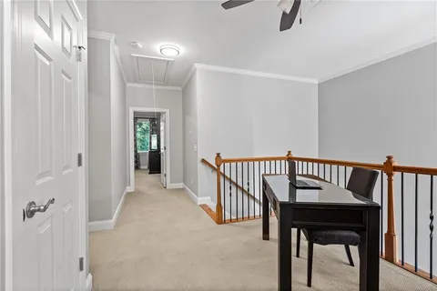 a view of a hallway to a livingroom with furniture