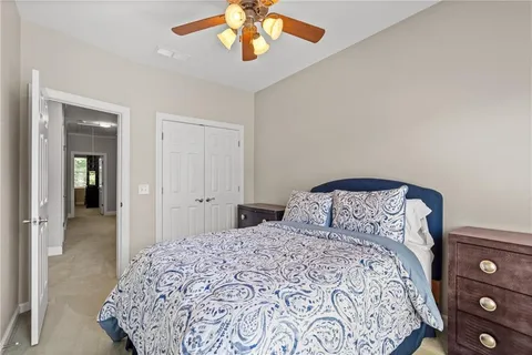 a bedroom with a large bed and a chandelier