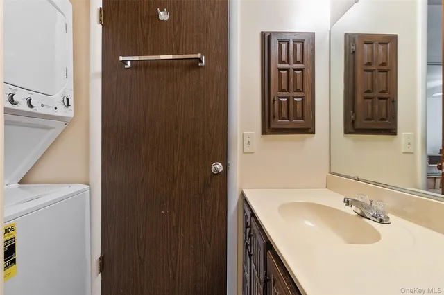 a bathroom with double vanity sink and two mirror