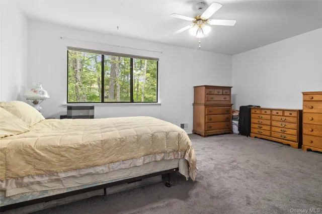 a large bed sitting in a room next to a window