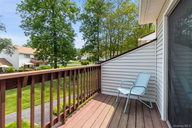 a view of balcony with wooden floor and fence
