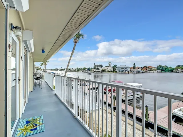 a view of a lake with couches chairs