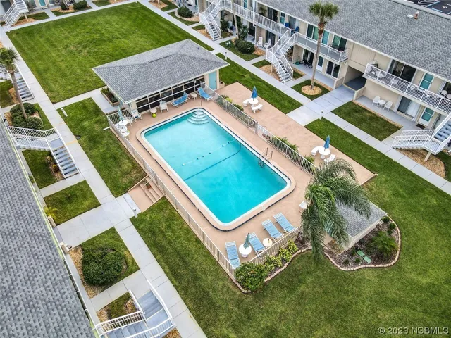 an aerial view of a pool table and chairs in the patio