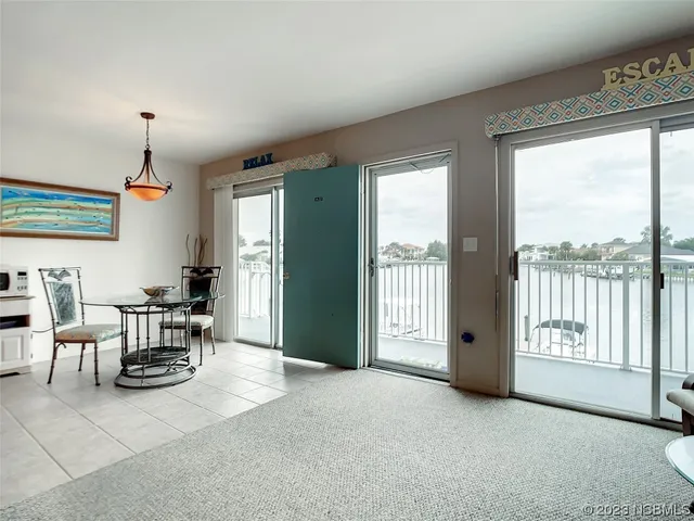 a view of a livingroom with furniture and floor to ceiling window