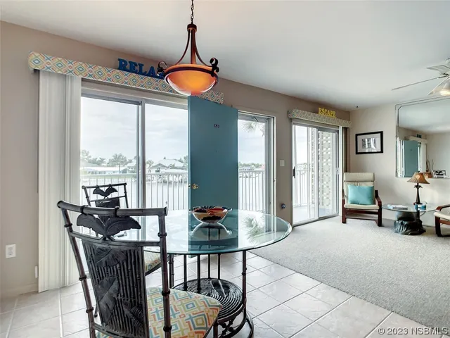 a view of a dining room with furniture window and outside view