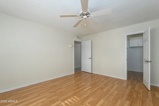 a view of empty room with wooden floor