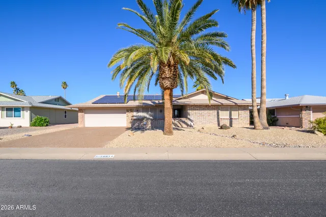 a row of palm trees and a swimming pool in the backyard of a house