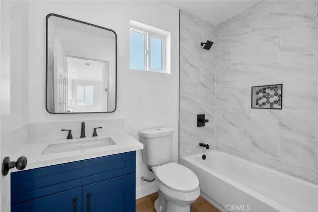 a bathroom with a sink toilet a mirror and shower