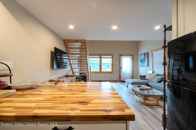 a room with pool table and a flat screen tv