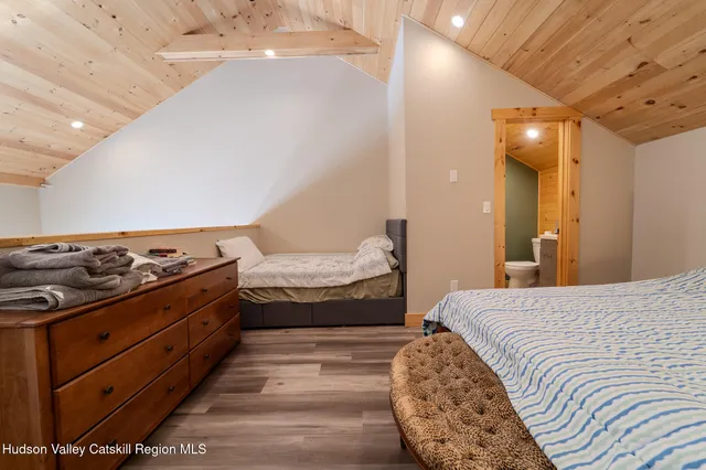 a bedroom with a bed and a mirror