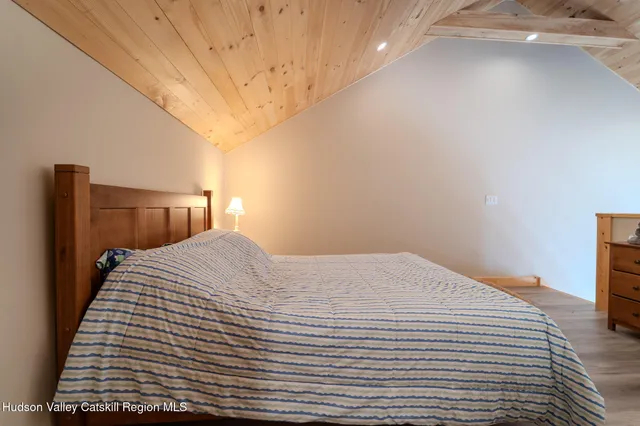 a bedroom with a bed and a night stand