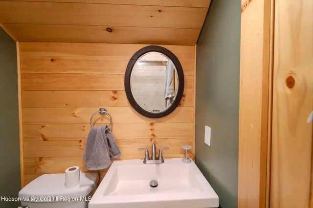a bathroom with a sink a mirror and a shower