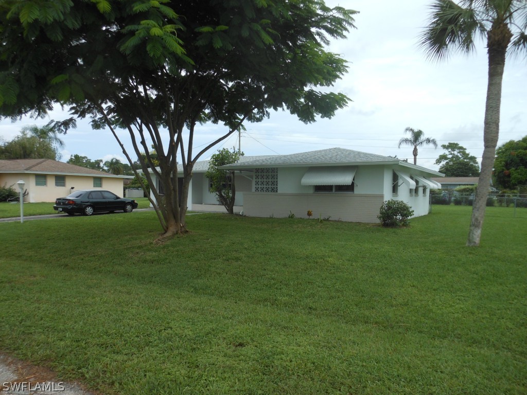 803 East Bougainvillea Road Lehigh Acres, FL 33936 - Photo 1 of 20 a front view of a house with a garden