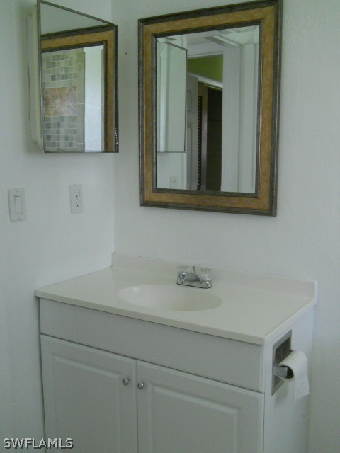 803 East Bougainvillea Road Lehigh Acres, FL 33936 - Photo 15 of 20 a bathroom with a sink and a mirror