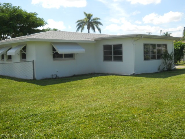 803 East Bougainvillea Road Lehigh Acres, FL 33936 - Photo 20 of 20 a house view with a garden space