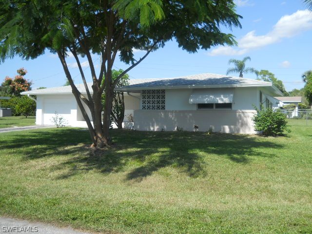 803 East Bougainvillea Road Lehigh Acres, FL 33936 - Photo 3 of 20 a view of a house with a yard