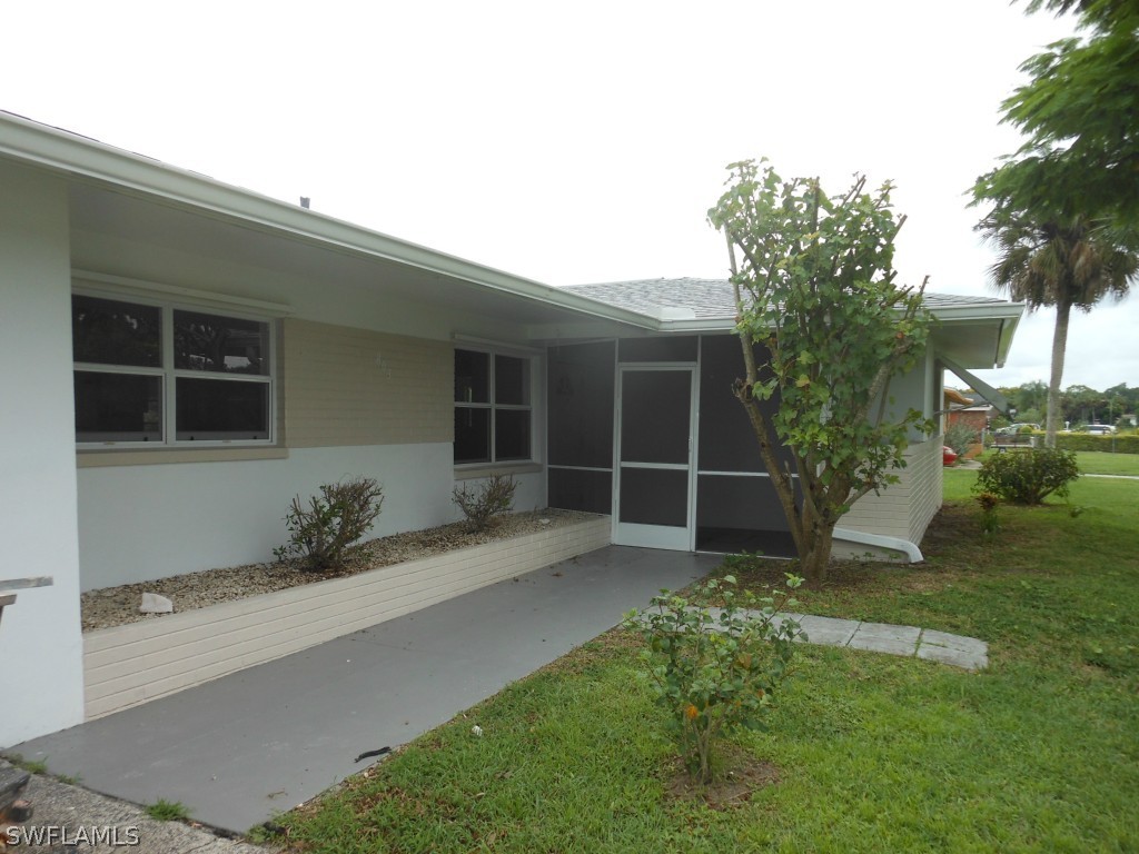 803 East Bougainvillea Road Lehigh Acres, FL 33936 - Photo 4 of 20 a house view with a garden space