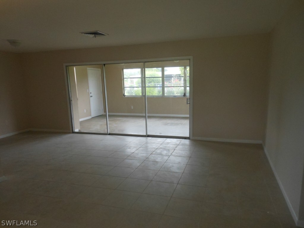 803 East Bougainvillea Road Lehigh Acres, FL 33936 - Photo 8 of 20 a view of an empty room with glass door