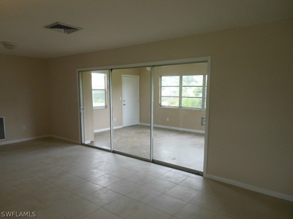803 East Bougainvillea Road Lehigh Acres, FL 33936 - Photo 9 of 20 an empty room with windows