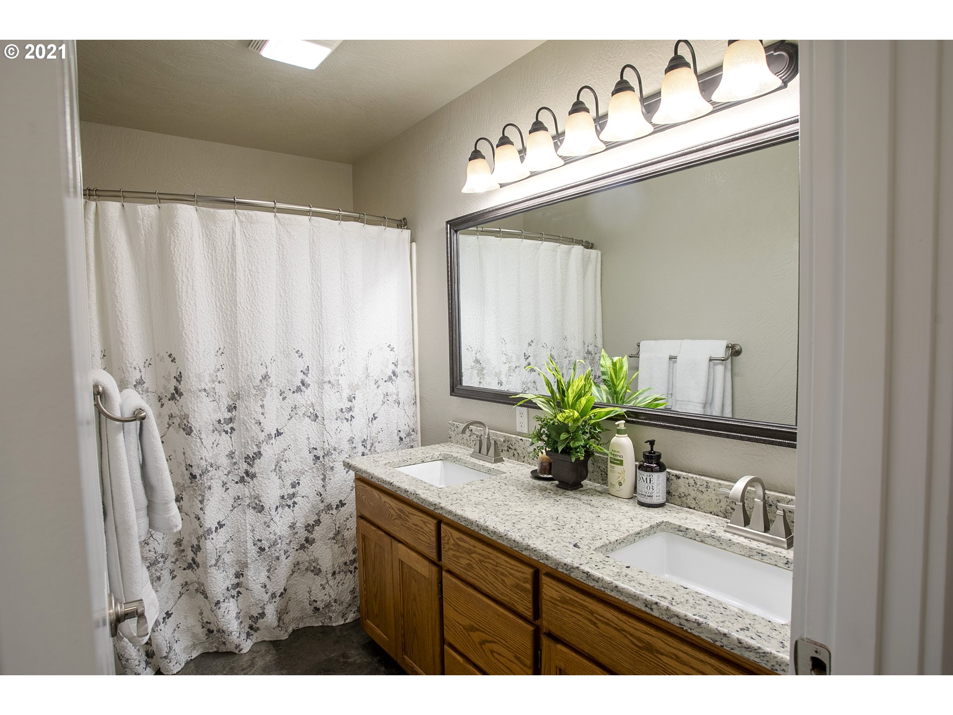 313 72nd Place Springfield, OR 97478 - Photo 29 of 32 a bathroom with a granite countertop sink and a mirror