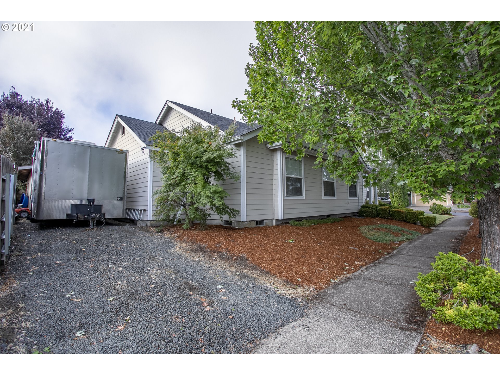 313 72nd Place Springfield, OR 97478 - Photo 3 of 32 a backyard of a house with plants and trees