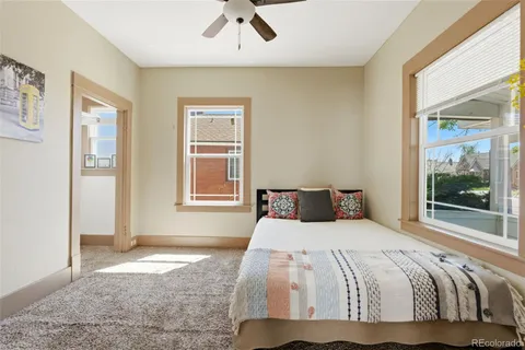 a bedroom with a large bed and a window