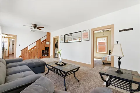 a living room with furniture a rug and a window