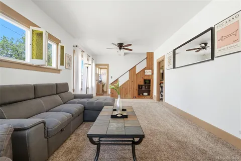 a living room with furniture a rug and a window