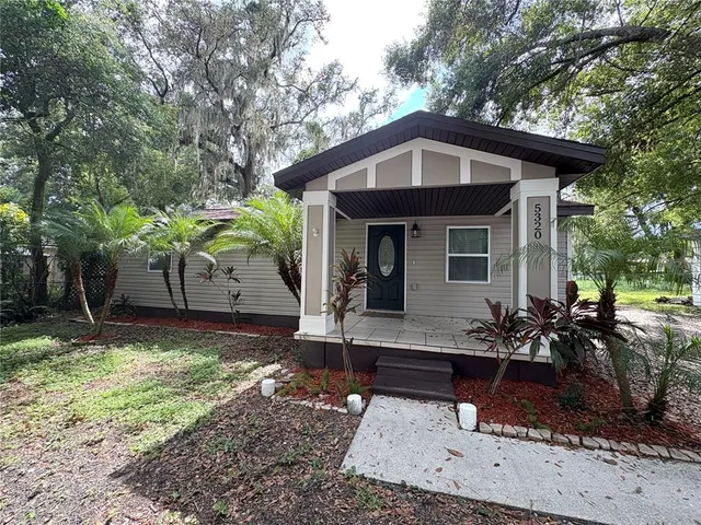 a front view of house with yard outdoor seating and barbeque oven