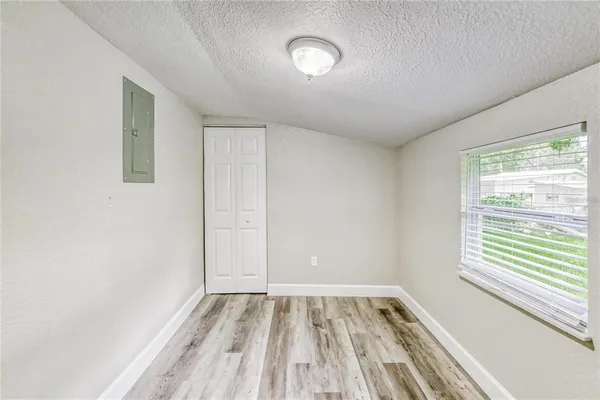 a view of a room with wooden floor and window