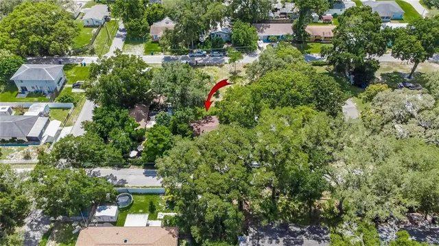 an aerial view of a house with a yard and outdoor seating