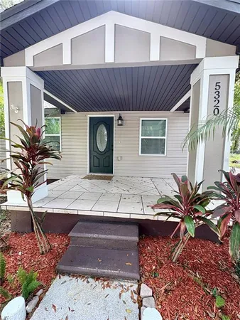 a view of a house with a yard and garage