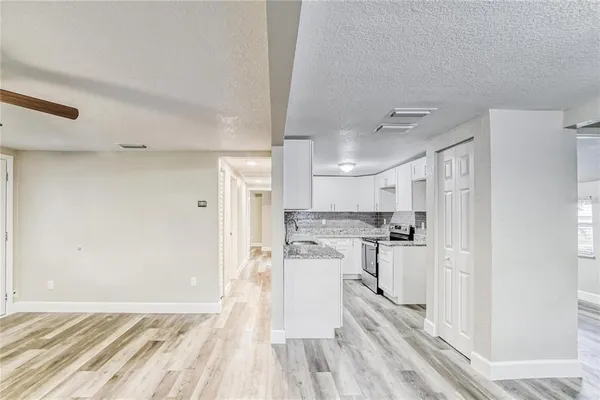 a kitchen with stainless steel appliances a refrigerator and a stove top oven