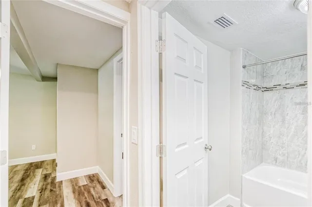 a bathroom with a bathtub and shower