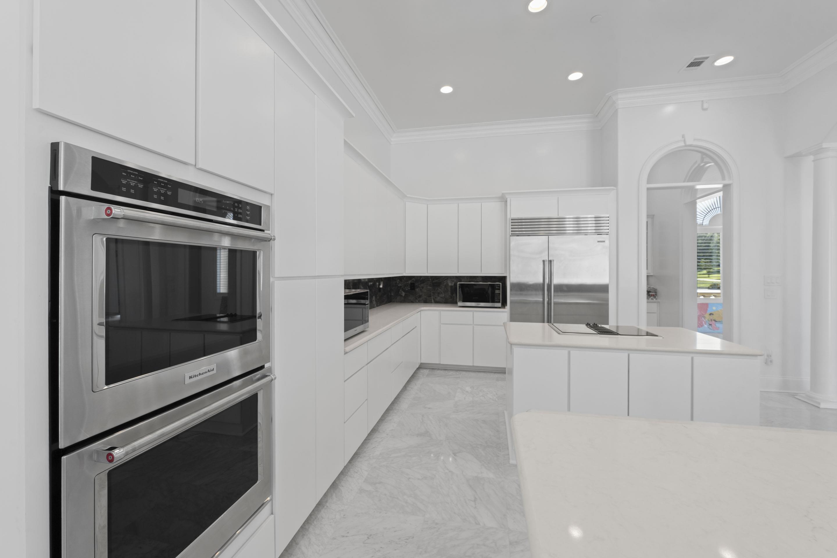 881 Bray Station Road Collierville, TN 38017 - Photo 7 of 40 a kitchen with stainless steel appliances kitchen island granite countertop a stove a microwave and a refrigerator