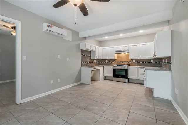 a large kitchen with cabinets and stainless steel appliances