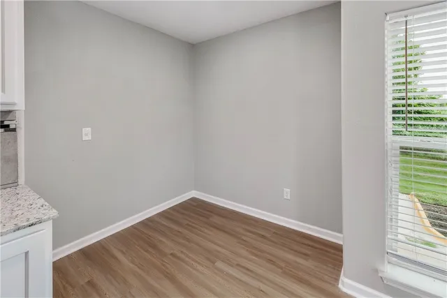 a view of an empty room and wooden floor