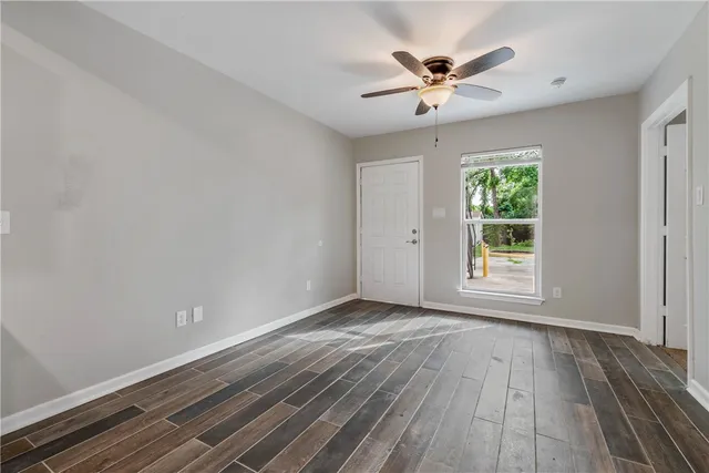 wooden floor in an empty room with a window